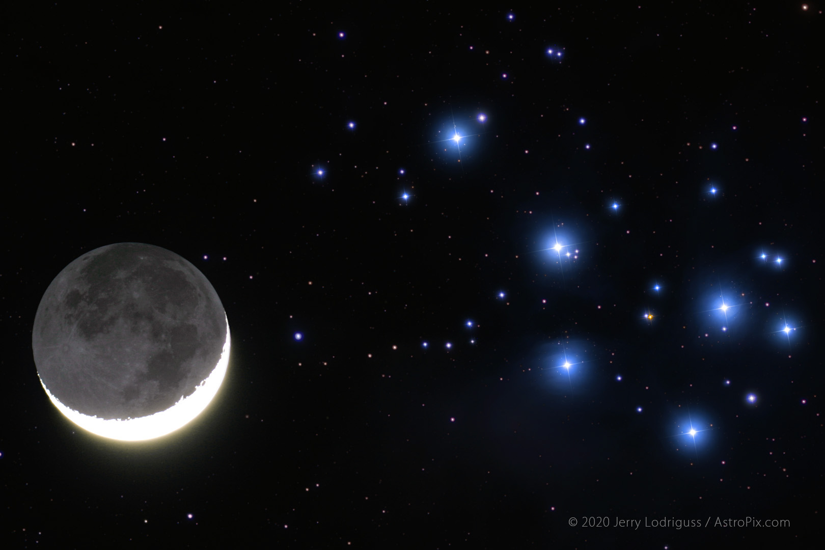 The crescent Moon with Earthshine passes near M45, The Pleiades. This is the same time as the previous image, but shot with a telescop of 612mm focal length.