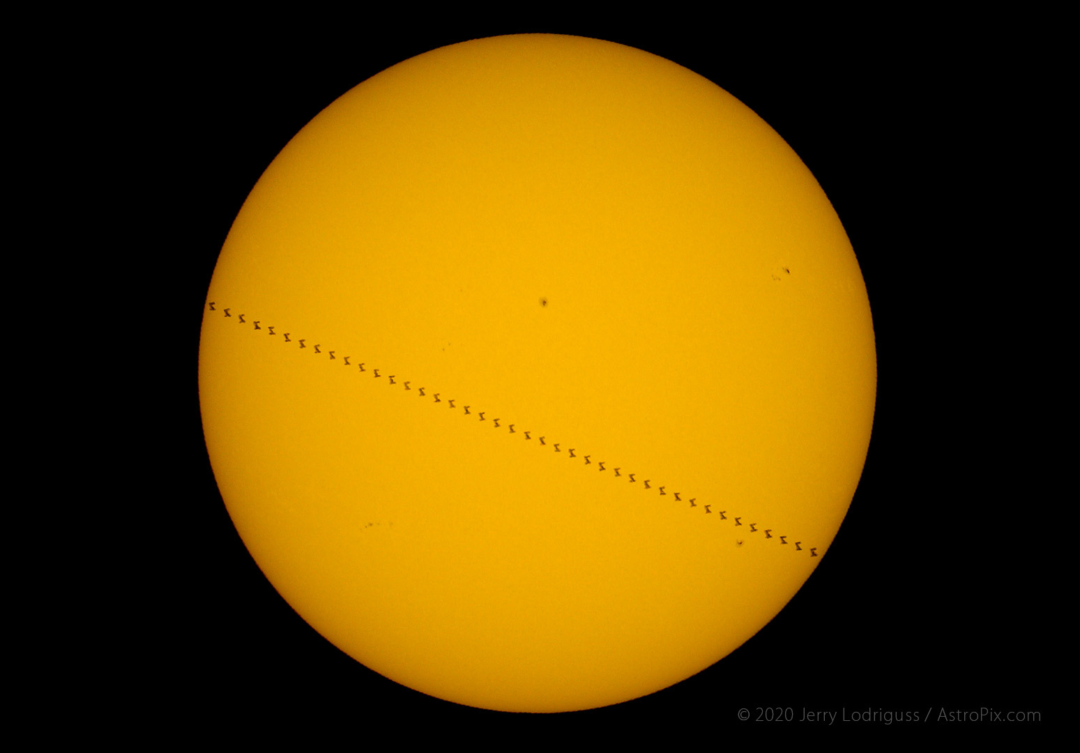 The International Space Station with the Space Shuttle Atlantis docked transit across the face of the Sun on July 17, 2011 at 8:09:20.10 a.m. EDT.  Transit-Duration: 1.42s, path width: 9.48km, Diameter of ISS: 33.80 arc seconds. Observed from Philadelphia, PA, USA at Longitude: -75d00m08.4s  Latitude: +40d07m34.8s.