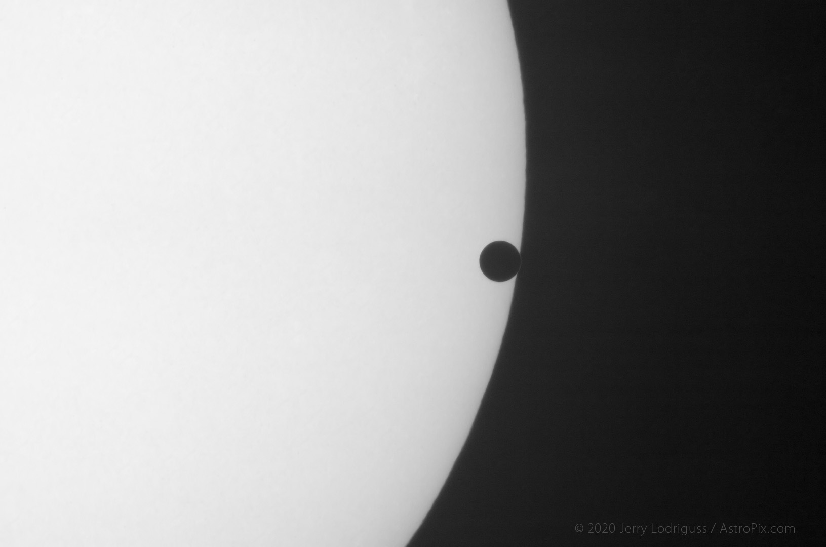 The atmosphere of Venus is visible as a short arc refracting sunlight and completing the circle of the silhouette of Venus as it egresses the Sun during the 2004 transit of Venus.