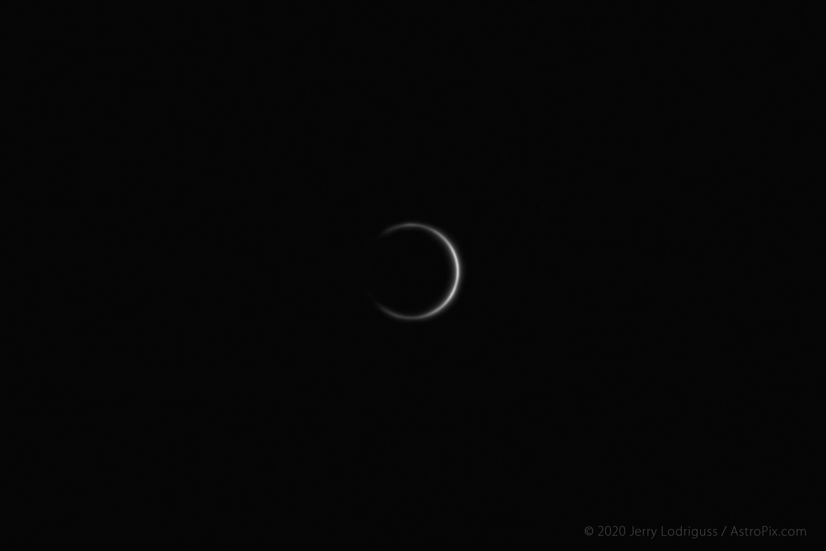Venus is seen on June 7, 2012, 42 hours after transiting the Sun. Sunlight diffusing through the atmosphere of the planet is visible almost 360 degrees around because it is backlit, extremely close to the Sun.