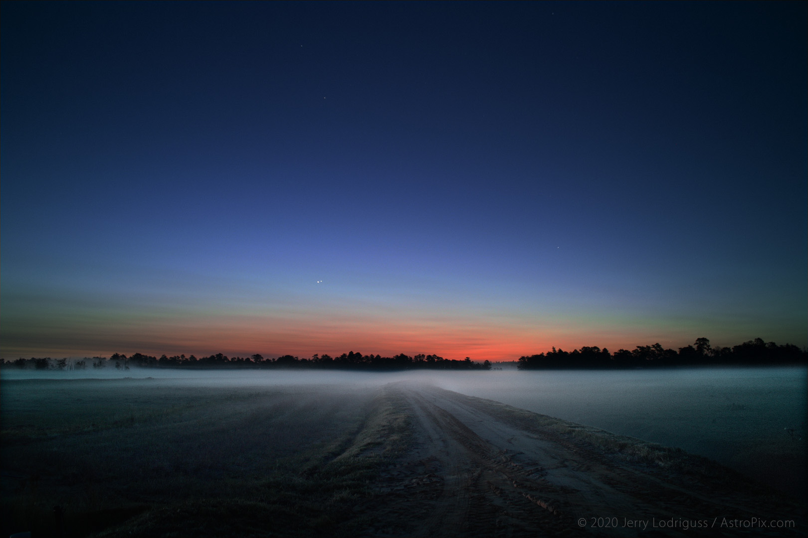 Venus and Jupiter hang together in conjunction on August 18, 2014 above the fog on the cranberry bogs in the Pine Barrens of New Jersey.