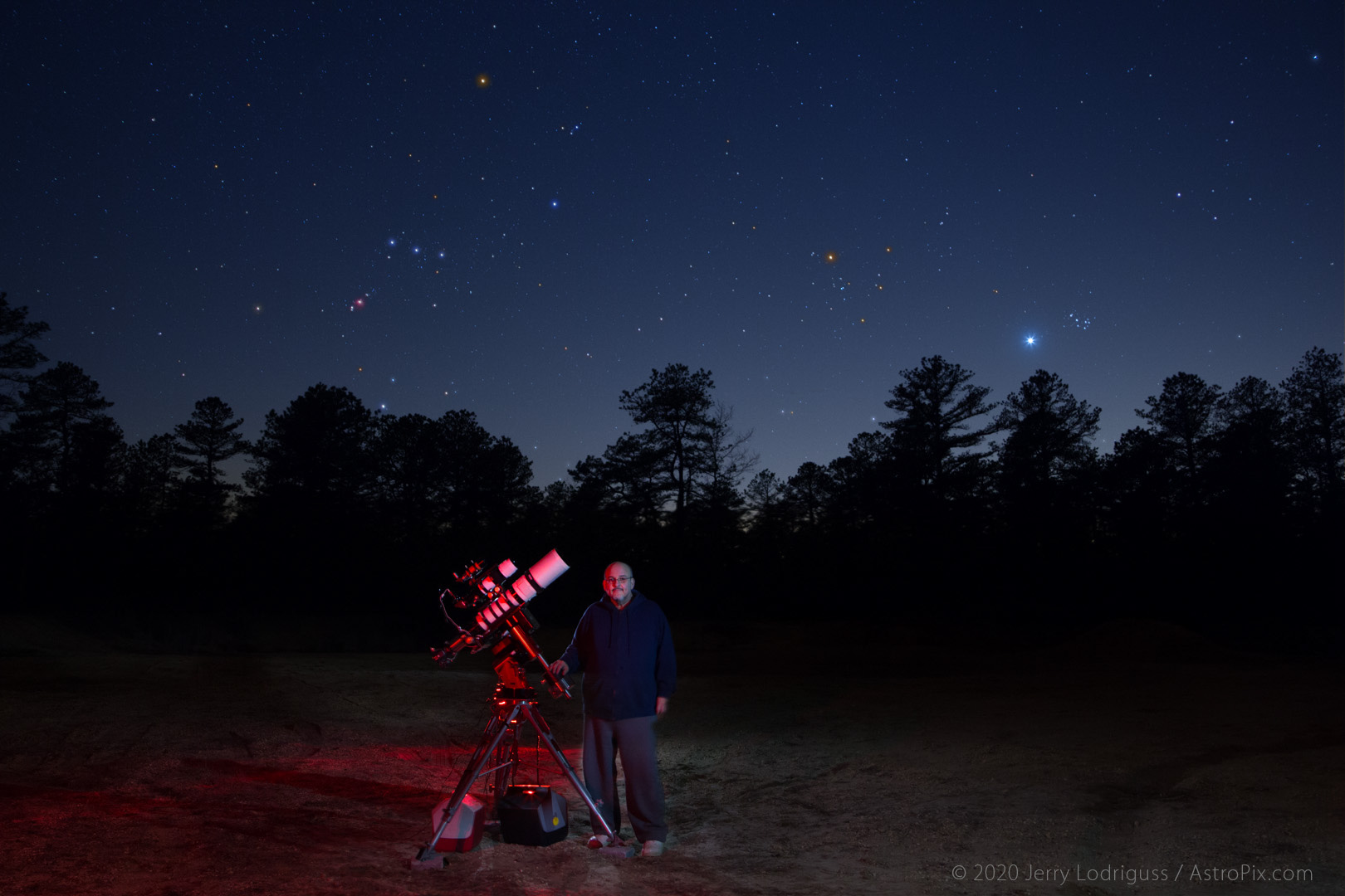 Self-portrait by Jerry Lodriguss with Orion, the Hyades, Venus, and the Pleiades setting in the west.