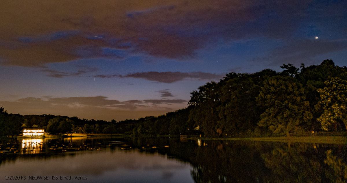 Comet NEOWISE peaks from behind the clouds as the sky brightens from dawn, the ISS flies over the comet, and Venus rises ar far right over Silver Lake at 4:33 a.m. EDT on July 11, 2020. Galaxy S10, 4.3mm lens, f/1.5, 8-second exposure, ISO 100.