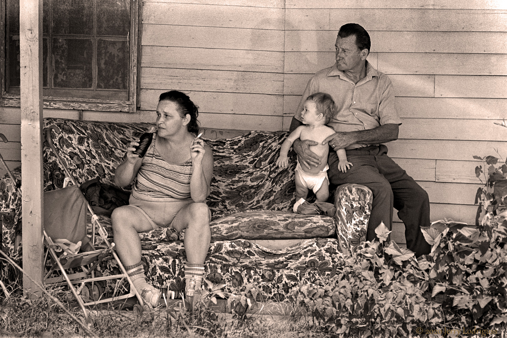 A family sits on their front porch in Bucktown.