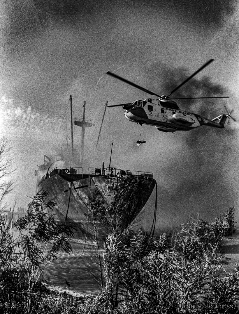 8/30/1979 GOOD HOPE, LA: A Coast Guard helicopter air lifts an injured seaman from the burning freighter Inca Tupac Yapanqui during rescue operations here 8/30. THe greighter caught fire after colliding with three butane barges in the Mississippi River. Nine crewman were missing and 29 were injured.