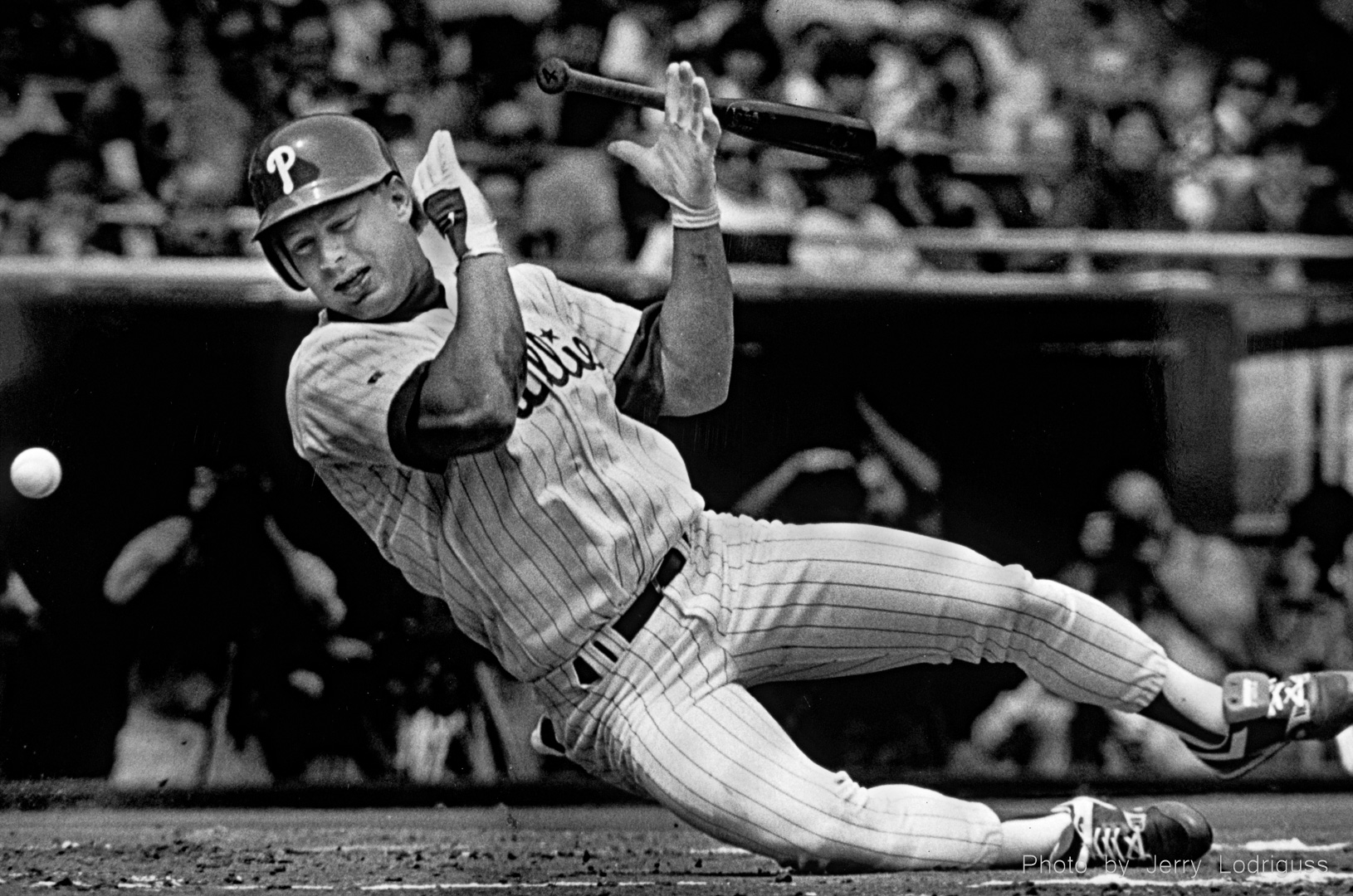 Phillies' lead off hitter Lenny Dykstra goes down after being hit by the second pitch in the game in his first at bat on opening day in 1992. Dykstra sustained a broken bone in his wrist on the pitch by the Atlanta Braves' Greg Maddux.