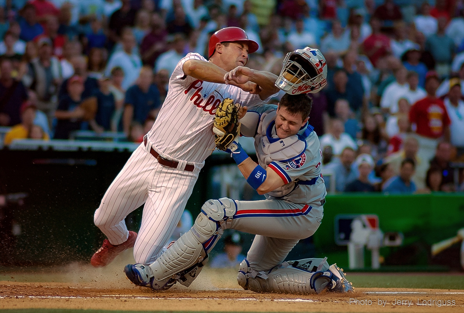 Phillies Pat Burrell is out at home as he crashes into Expos catcher Brian Schneider trying unsuccessfully to score from first base on a hit by Tyler Houston in the second inning of this 2004 game.