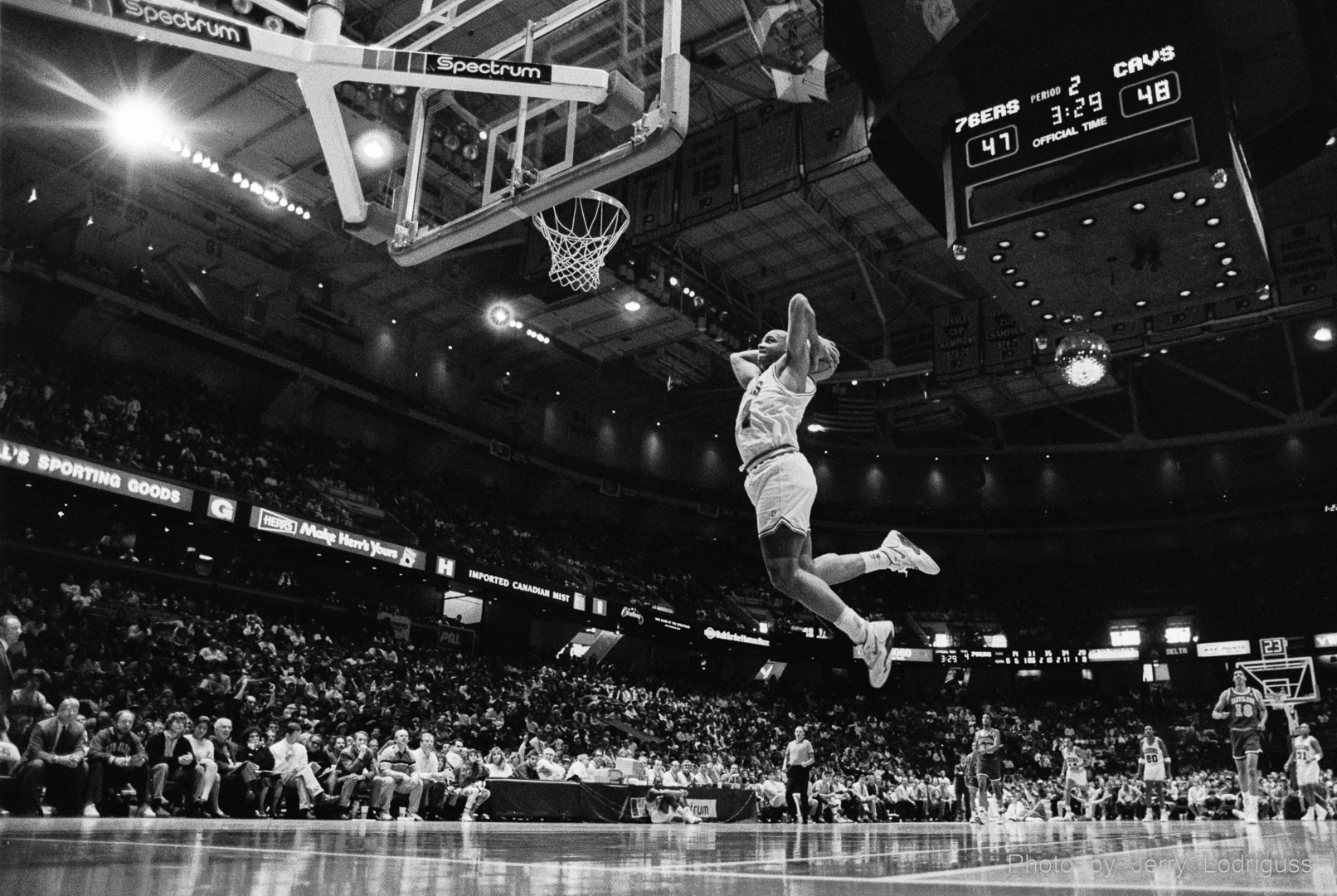 The Philadelphia 76ers' Charles Barkley throws down a thunderous two-handed tomahawk dunk after a breakaway steal against the Cleveland Cavaliers in the Spectrum on March 31, 1991.