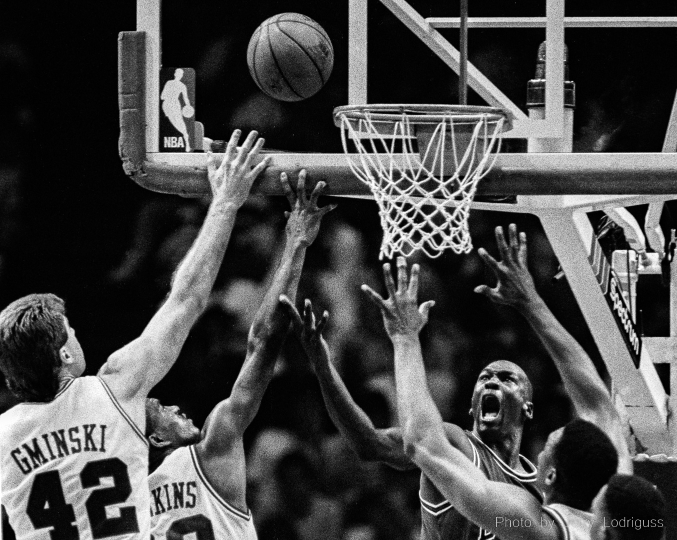 Michael Jordan scores from behind the goal through a forest of hands from Mike Gminsky, Johnny Dawkins and Rick Mahorn trying unsuccessfully to defend against him in this 1991 playoff game in Philadelphia between the Chicago Bulls and Philadelphia 76ers.