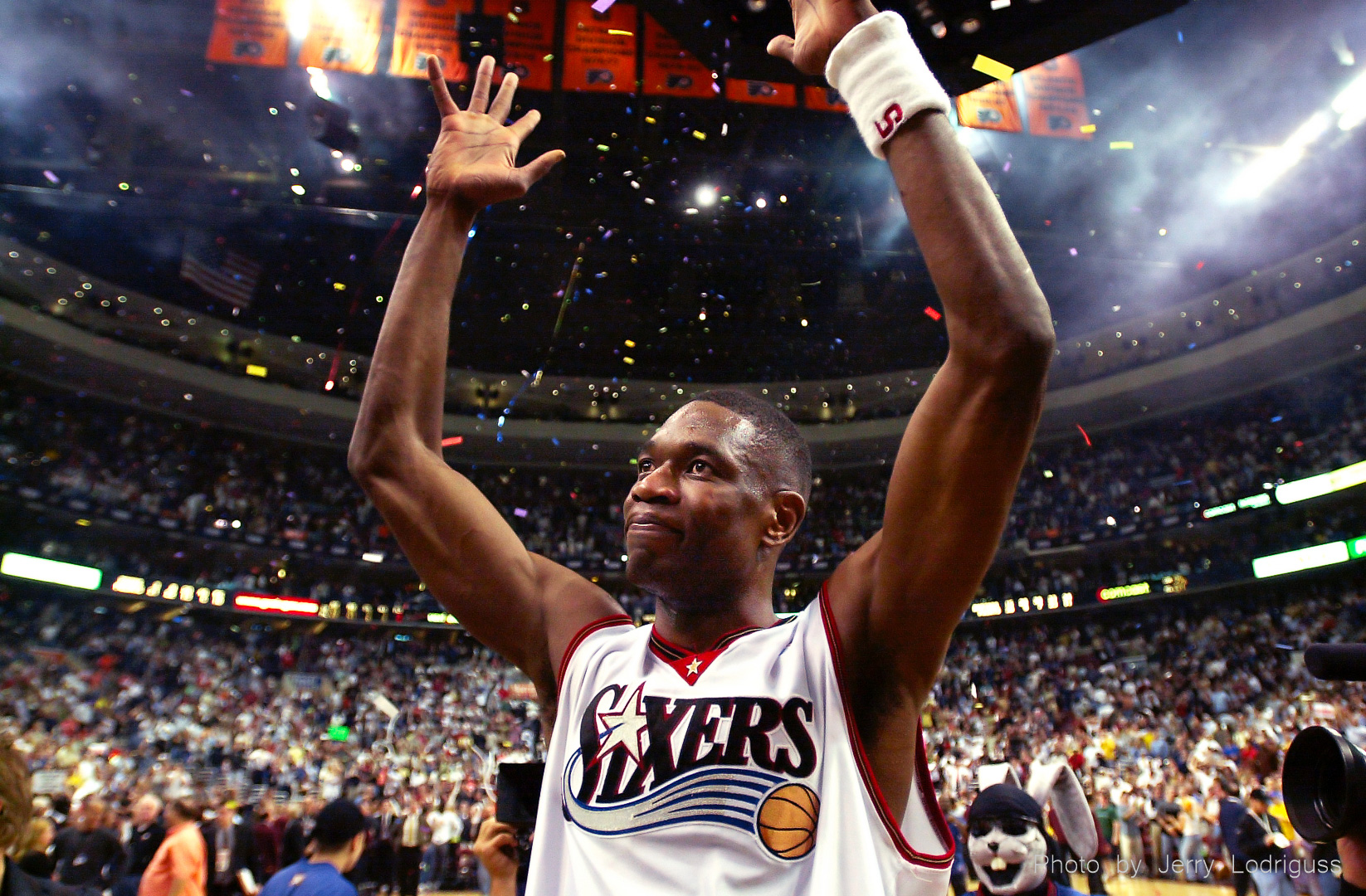 Confetti falls from the sky as the Sixers' Dikembe Mutombo celebrates Philadelphia's 88-87 victory over Toronto in Game 7 of the Eastern Conference Finals on May 20, 2001 in Philadelphia.