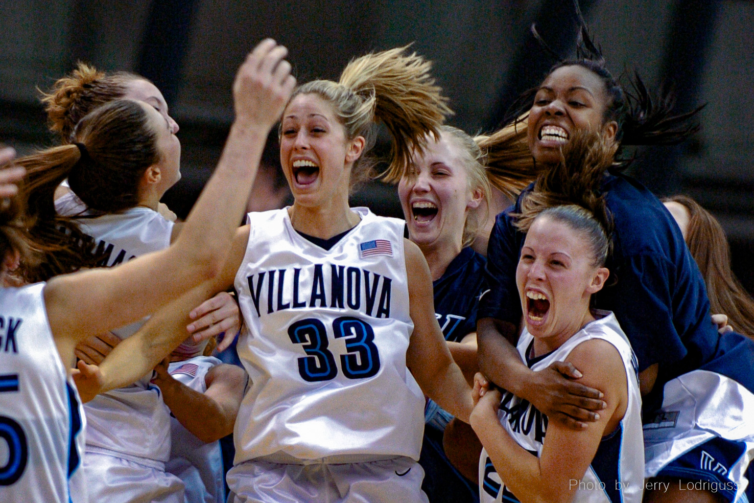 Villanova players celebrate a 59-56 upset win over the #1 ranked Connecticut Huskies. From left are Jenna Viani, Courtney Roantree, Sarita Hatcher (top), and Jennifer Hilgenberg.