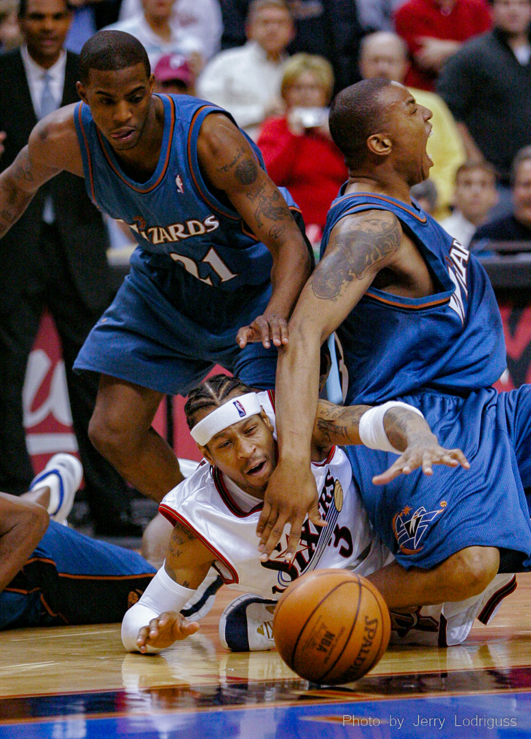 Caron Butler screams as he twists his ankle under Allen Iverson as Iverson dives for a loose ball. The Philadelphia 76ers faced the Washington Wizards and won 119-113 at the Wachovia Center on Friday March 3, 2006.