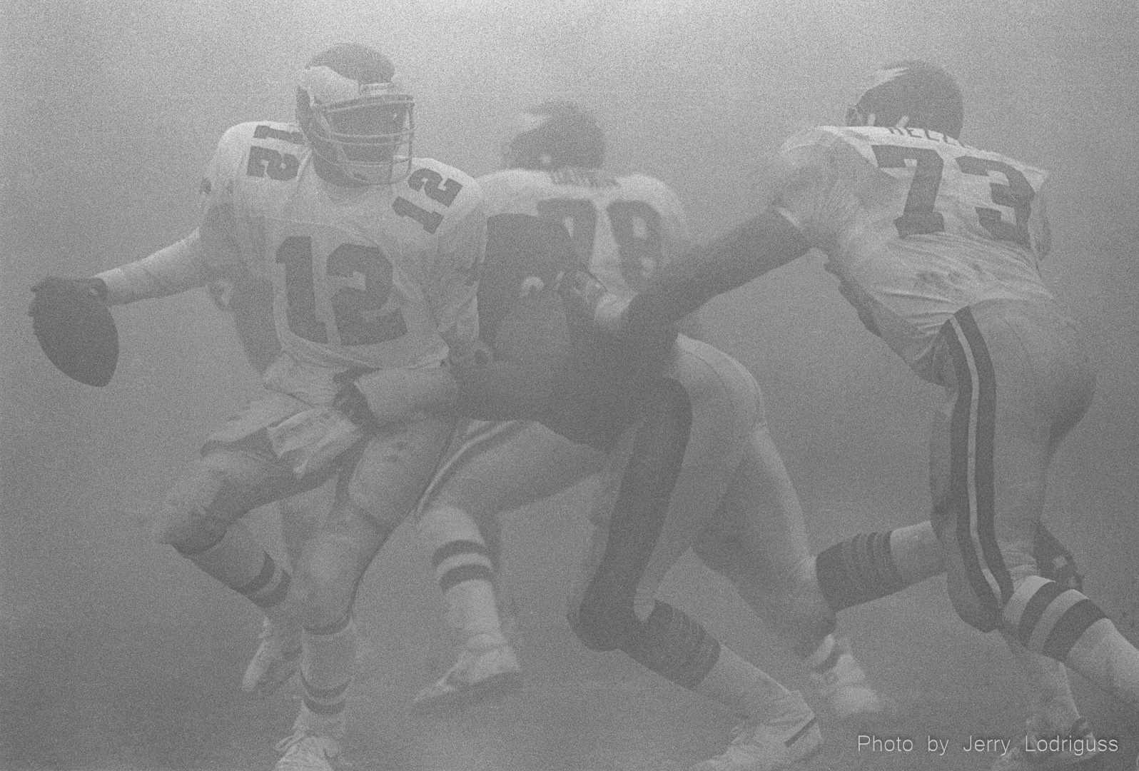 Eagles Quarterback Randall Cunningham scrambles in the fog during the "Fog Bowl" on  December 31, 1988 in a National Football League playoff game between the Philadelphia Eagles and the Chicago Bears. A heavy, dense fog rolled over Chicago's Soldier Field during the 2nd quarter, cutting visibility to about 15-20 yards for the rest of the game. Philadelphia moved the ball effectively all day and Eagles quarterback Randall Cunningham had 407 passing yards, but they could not get the ball into the end zone. The Bears won 20-12.