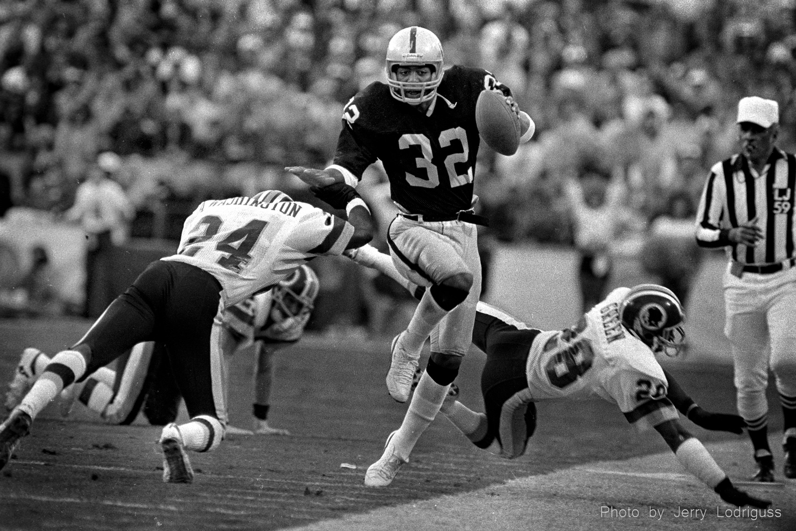Marcus Allen, MVP of Superbowl XVIII, dodges Redskins on his way to a big gain. The Los Angeles Raiders beat the Washington Redskins 38-9 in Tampa Florida on January 22, 1984.