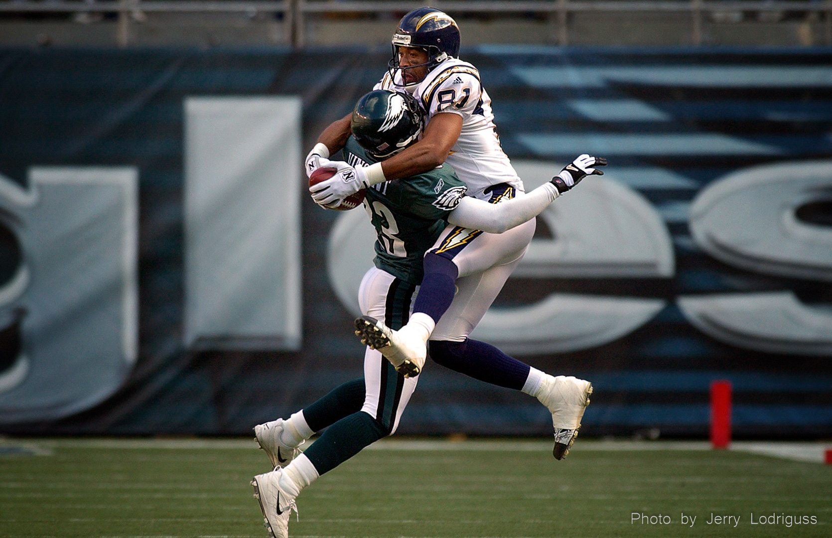 San Diego Chargers recievcer Jeff Graham goes through the Philadelphia Eagles cornerback Troy Vincent to chatch a Doug Flutie pass. The ball poped up in air after Graham's initial catch and Graham caught it again, running 61 yards for a Charger touchdown in the first quarter of the Eagles 24 - 14 victory on December 9, 2001.