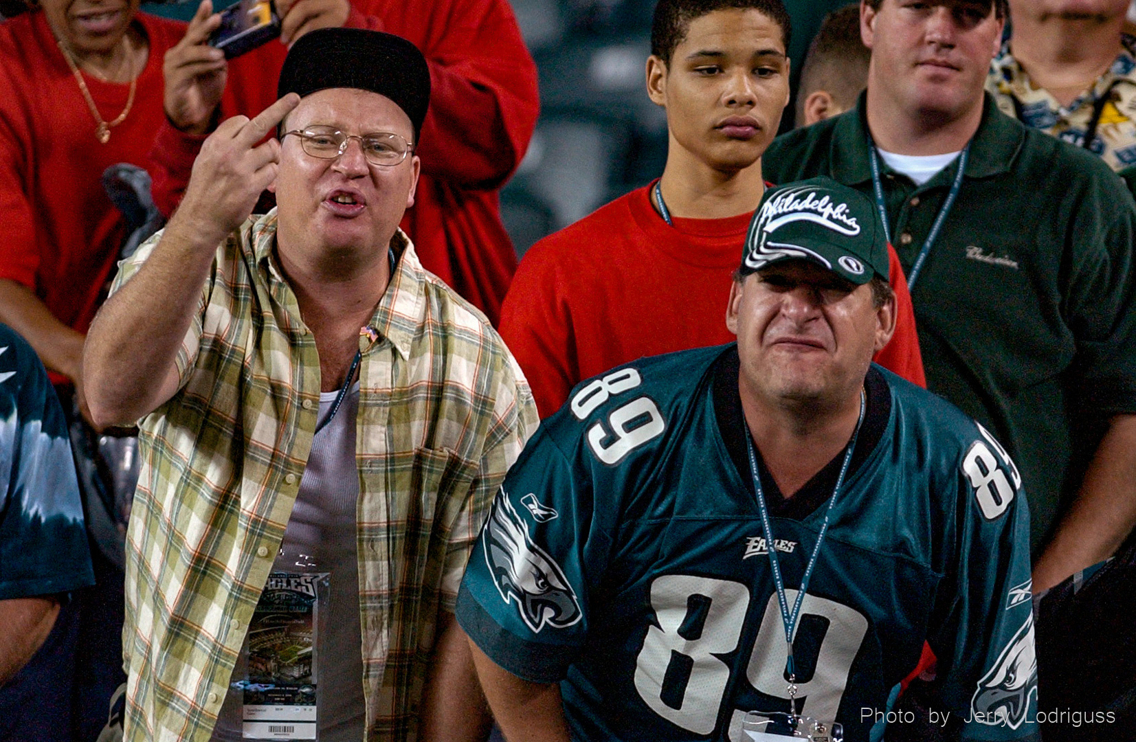 Unidentified Eagles fans express their displeasure by screaming obscenities at Eagles coach Andy Reid as he leaves the field after the Eagles 17-0 loss to Tampa on Monday September 8, 2002.