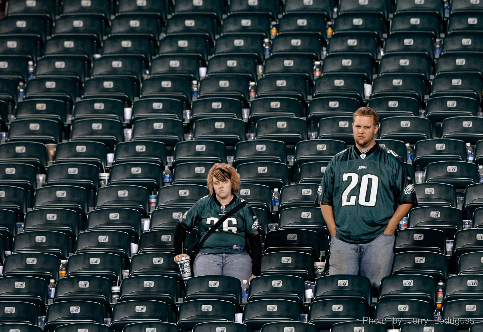 Two dejected Eagles fans stand with looks of disgust and unbelief on their faces in a section of empty seats after the Eagles had left the field following their last second loss to Chicago in Philadelphia on Sunday October 21, 2007.