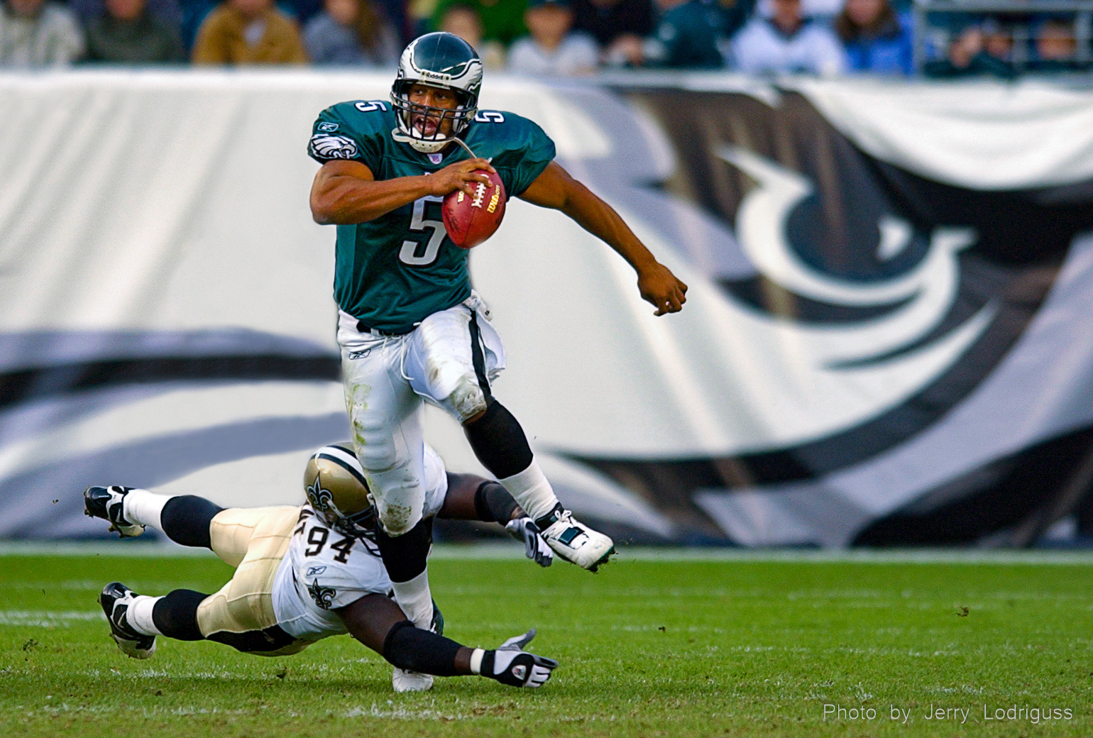 Eagles Donovan McNabb eludes the grasp of the Saints Charles Grant as he races upfield looking for a first down during the Eagels 33-20 win in Philadelphia on Sunday November 23, 2003.