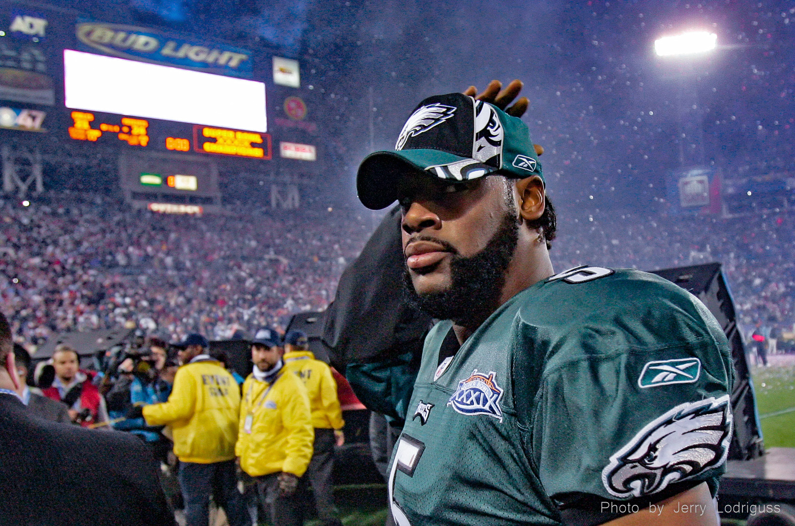 As the confetti rains down on the victorious Patriots, Eagles Donovan McNabb gets a pat on the head as he leaves the field after the Eagles 24-21 loss in Superbowl XXXIX in Jacksonville on Sunday February 6, 2005. McNabb was 30 for 51 in passing for 357 yards, and three touchdowns , but had 4 interceptions, one of which was nullified by a penalty, and one was made on the Patriots goal line killing an Eagles' scoring chance.