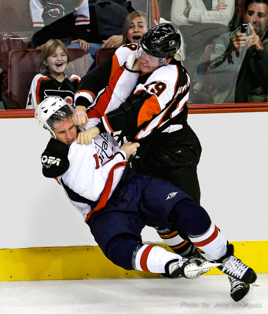 Young fams laugh as the Flyers' Scott Hartnell and the Capitals' Chris Clark punch each other in the face during a hockey fight on November 23, 2007.