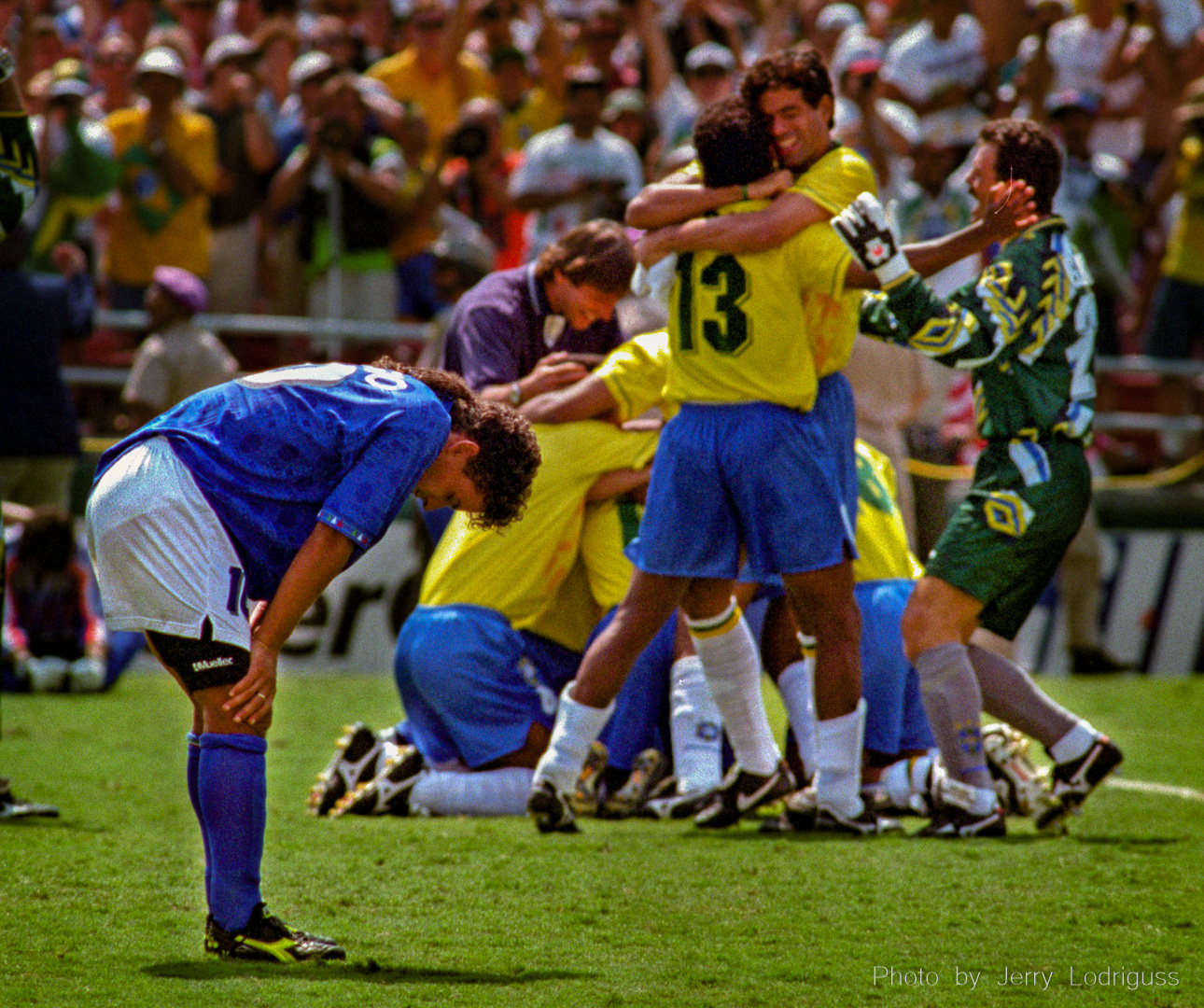 Italy's Roberto Baggio hangs his head as Brazil celebrates their 1994 World Cup Soccer championship in the background after Baggio missed Italy's final penalty kick. The two teams had played two scoreless periods as well as two scoreless overtimes, and the title game came down to penalty kicks for the first time ever, which Brazil won 3-2 when Baggio's shot sailed over the top bar of the goal. The game was played July 17, 1994 in front of 94,194 fans in the Rose Bowl in California and billions around the world. It was Brazil's fourth World Cup title.