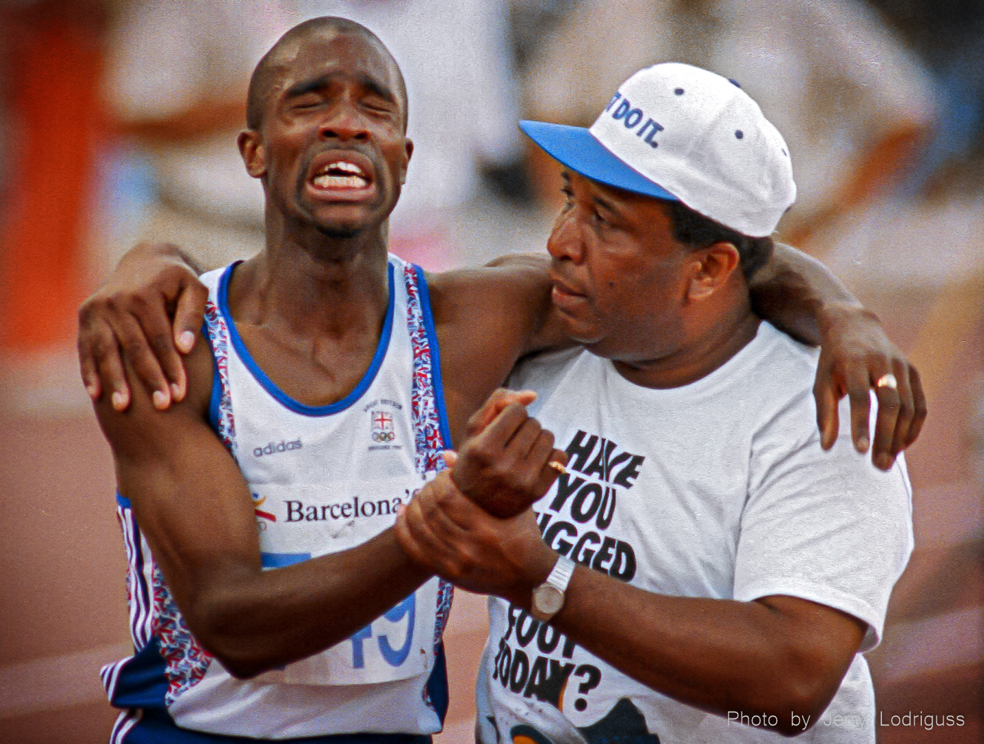 Derek Redmond of Great Britain is in agony as he is helped to the finish line by his father, Jim, after tearing his hamstring muscle in the semi-finals of the men's 400 meter run at the 1992 Barcelona Olympics.<br /><br />Redmond collapsed about half way through the race with the injury, but got up, determined to finish despite the pain. His father came out of the stands and onto the track to help his son. Redmond initially tried to push him away, not realizing who he was, but then heard a familiar voice. "Derek, it's me" his father said. Redmond told his father "I've got to finish this race." His father said "If you're gonna finish the race, we'll finish it together." With his father's help, Redmond made it to the finish line.<br /><br />Later, watching a video of that 1992 Olympic race, Redmond said "I don't think I've ever cried so much in my life. It's more embarrassing than anything else--men don't cry."