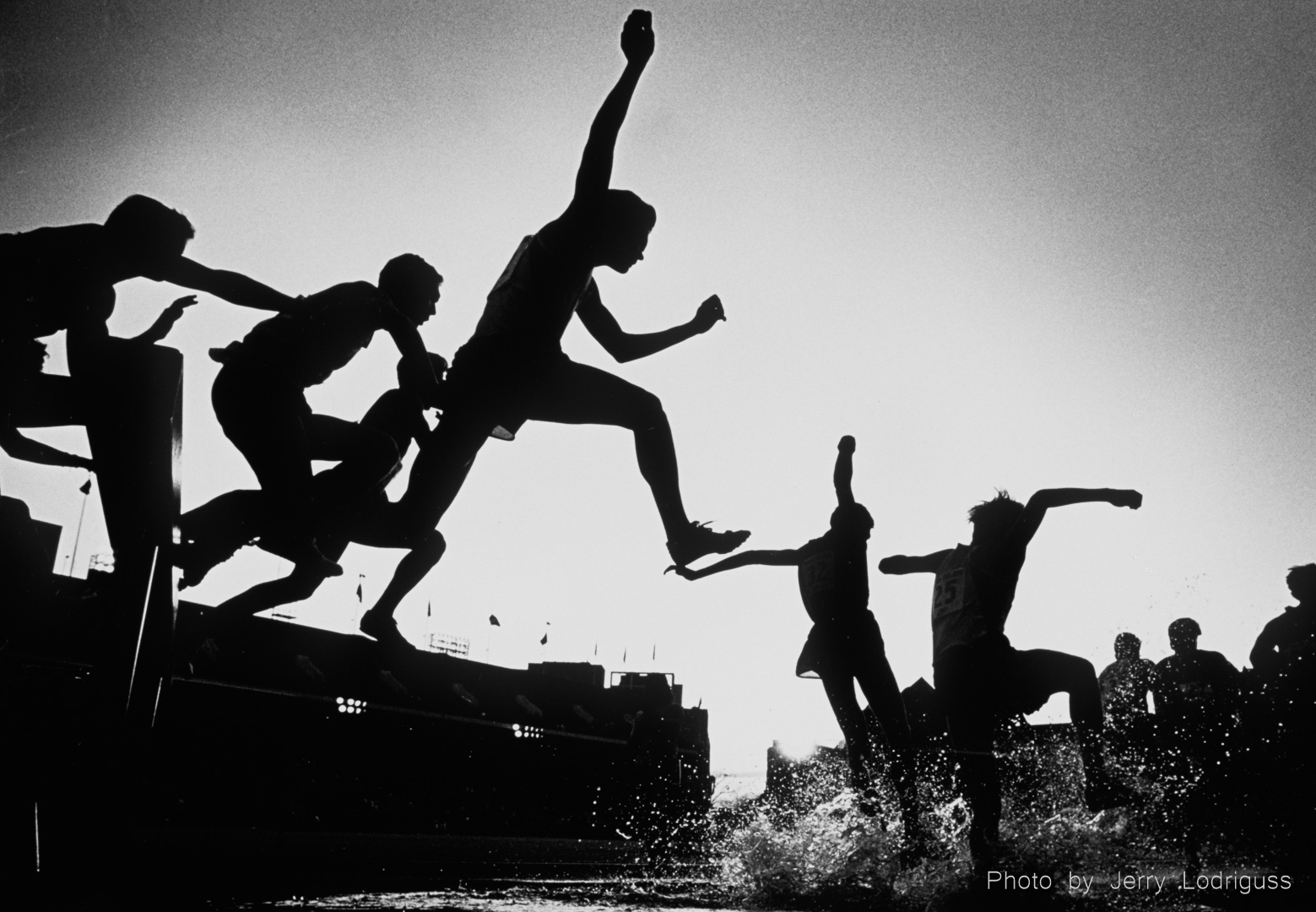 Runners clear the water hurdle during the Penn Relays Steeplechase event in 1992.